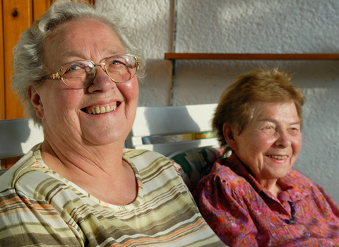 Women sitting on porch smiling