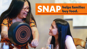 woman serving food to child