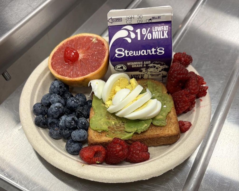 school breakfast including fruit, avocado toast, and milk