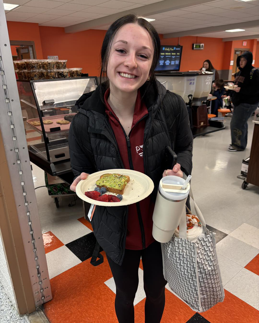 high school student holding school breakfast
