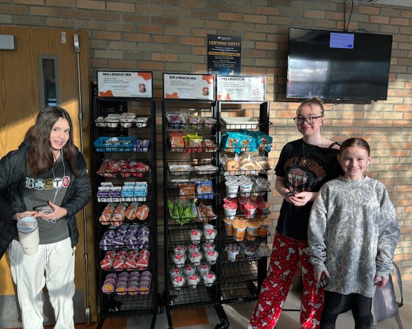 Middle school students at grab and go breakfast cart