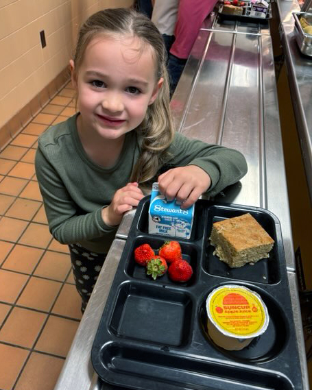elementary school student with school breakfast